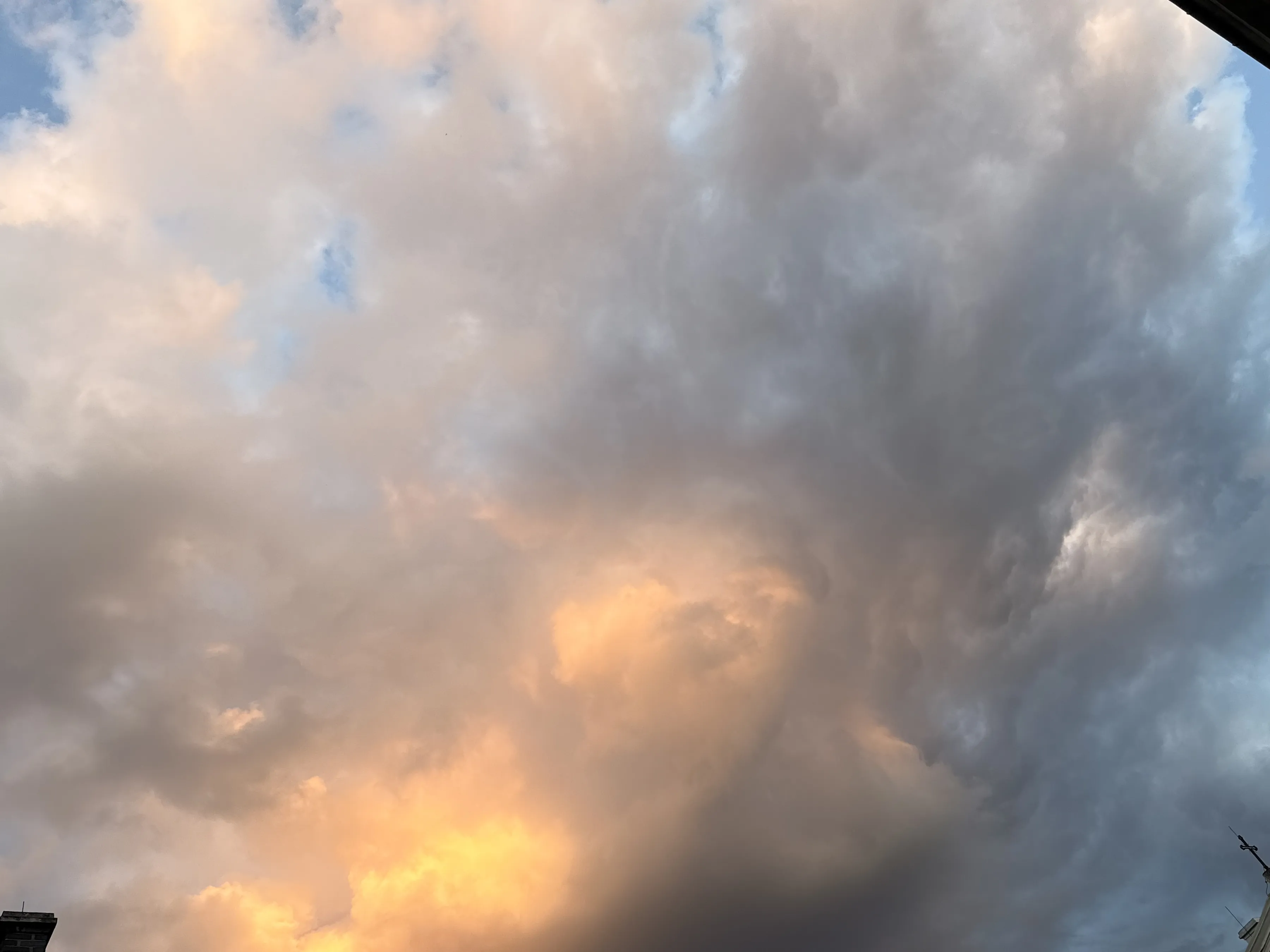 Evening storm clouds lit orange from below