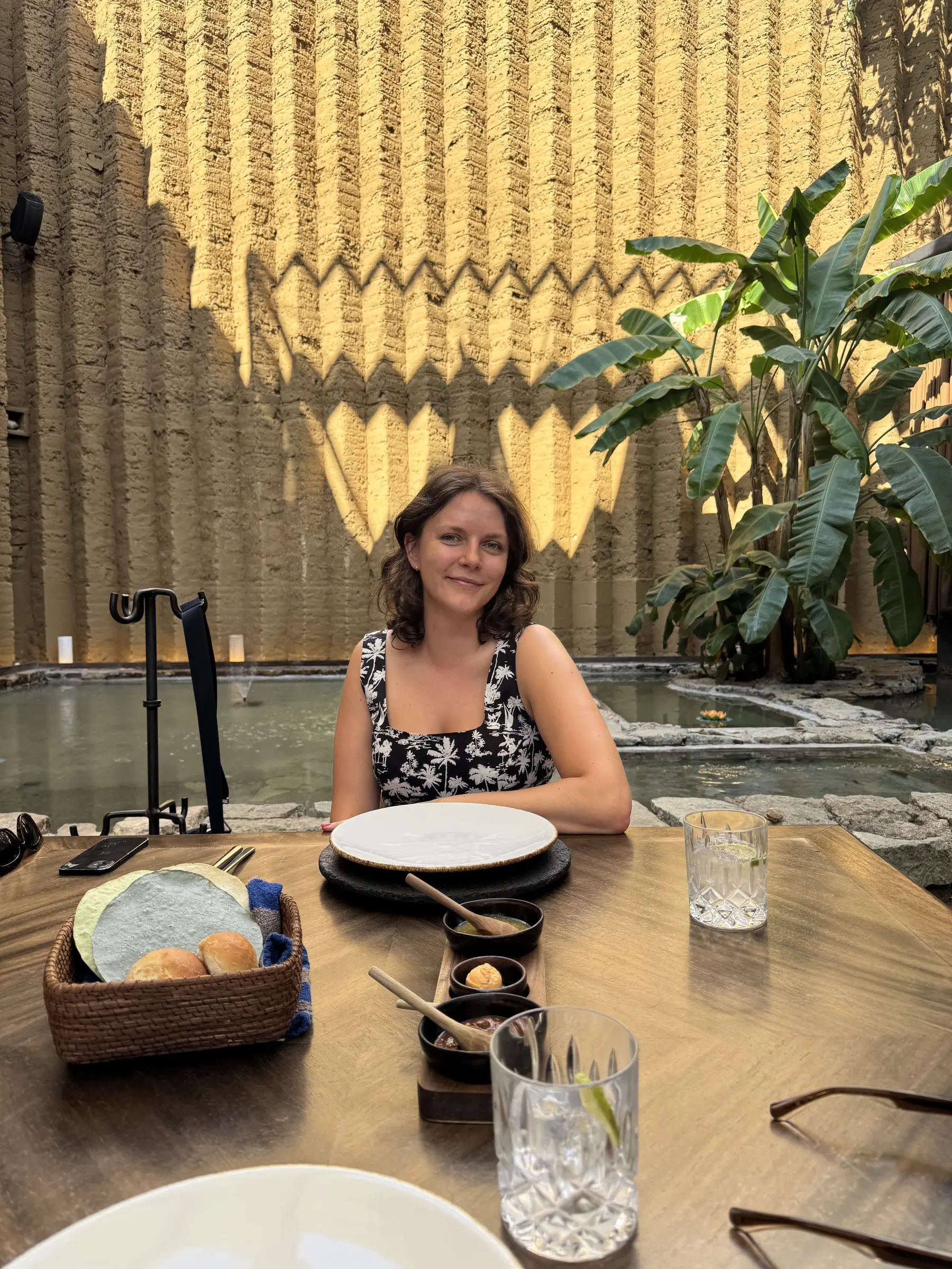 Ellyn Fitzgerald at a restaurant table in a sunlit courtyard